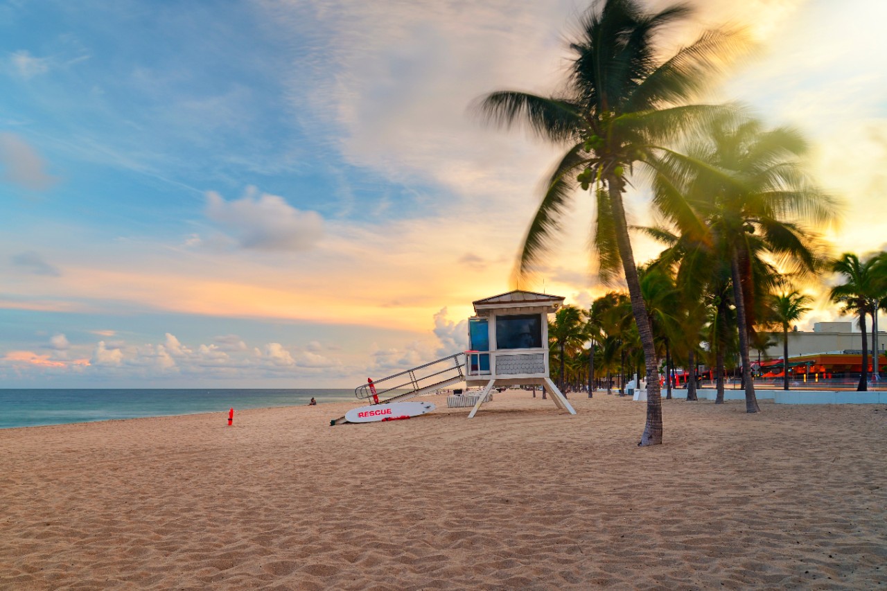 Sunset at Sunrise Beach in Ft.Lauderdale with palm trees and beach entry feature.